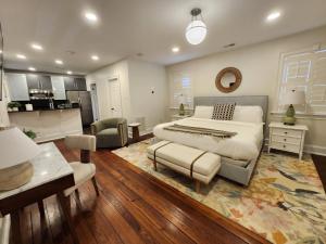 a bedroom with a large bed and a kitchen at Hamilton Carriage A - Amazing Location, Courtyard in Savannah +22 photos