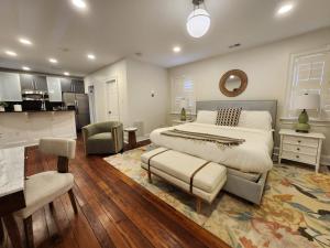 a bedroom with a large bed and a kitchen at Hamilton Carriage A - Amazing Location, Courtyard in Savannah