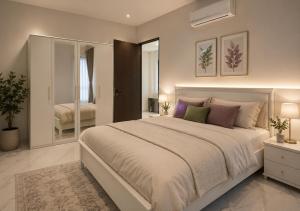 a bedroom with a large bed and a mirror at Chenz Guest House in Ancol