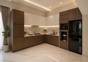 a large kitchen with white cabinets and a table at Chenz Guest House in Ancol