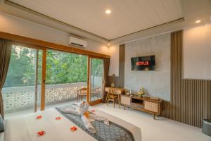 a child laying on a bed in a room at Arcana Ubud in Ubud