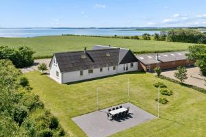 an aerial view of a large white house with a large yard at Spacious Holiday Home With Water View in Redsted