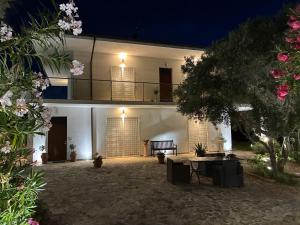 a large white building with a balcony at night at Casa Bianca in Silvi Marina