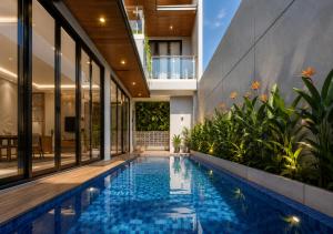 a swimming pool in the middle of a house at Chenz Guest House in Ancol