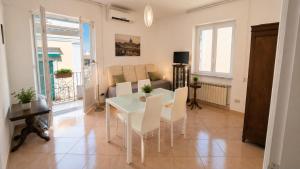 a living room with a table and chairs and a couch at Casa Giusto Ischia 3 in Ischia Town