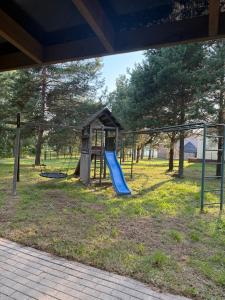 a playground with a slide and a play structure at Razna Lake House in Astici