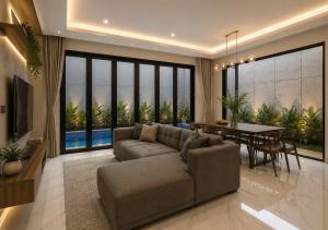 a living room with a couch and a dining room at Chenz Guest House in Ancol