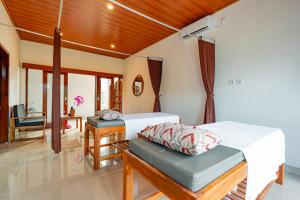 a bedroom with two beds and a desk at The Siantar Luxury Villa And Spa in Nusa Penida +46 photos