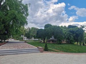 a park with trees and a lawn with stairs at Miradi Art Apartment in Stara Zagora