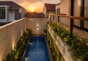 a swimming pool on the balcony of a house at Chenz Guest House in Ancol +3 photos
