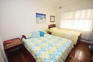 a bedroom with a bed and a bed and a table at 13 High Street in Nambucca Heads