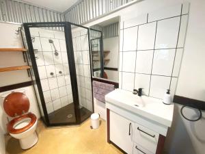 a bathroom with a shower and a toilet and a sink at 10 Clarke in Nambucca +23 photos
