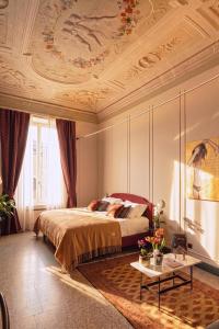 a bedroom with a bed and a coffered ceiling at Homeby, Cinisca Suite Rose in Bologna