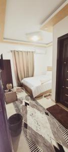 a bedroom with two beds and a door in it at Pyramids Aladdin Power in Cairo