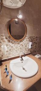 a bathroom with a white sink and a mirror at Pyramids Aladdin Power in Cairo +103 photos