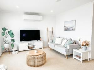 a living room with a couch and a tv at 59 Short in Nambucca Heads