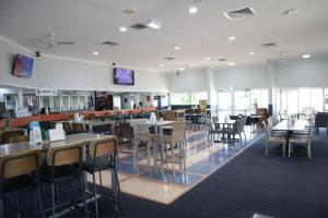a dining room with tables and chairs in a restaurant at The Hotel Pioneer Brandon in Brandon