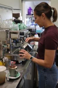 a woman standing in a kitchen preparing food at The Hotel Pioneer Brandon in Brandon +6 photos