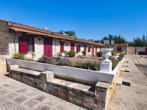 a row of buildings with plants in a courtyard at Holiday Residence in Casamassima