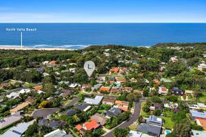 an aerial view of a suburb with the ocean at Coastal Charm in Valla Beach +4 photos