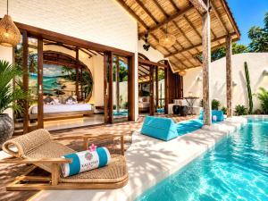 a villa with a swimming pool and a resort at Kaleydo Villas in Gili Trawangan