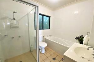 a bathroom with a tub and a toilet and a sink at Estuary in Nambucca Heads +15 photos