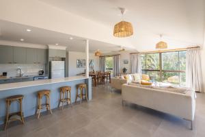 a kitchen and living room with a couch and a table at Coastal Chill in Nambucca Heads
