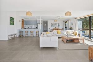 a living room with a white couch and a table at Coastal Chill in Nambucca Heads
