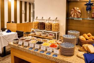 a buffet with different types of food on a table at Wyndham Bogota in Bogotá