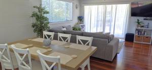a living room with a table and a couch at Riverwood in Nambucca Heads