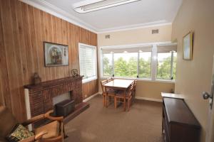 a living room with a table and a fireplace at The Outlook in Nambucca Heads