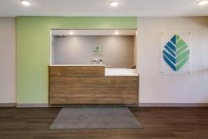 a bathroom with a mirror on the wall and a counter at WoodSpring Suites Knoxville West in Knoxville