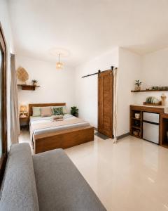 a living room with two beds and a couch at Pascoe's Units Siargao- Suites in General Luna
