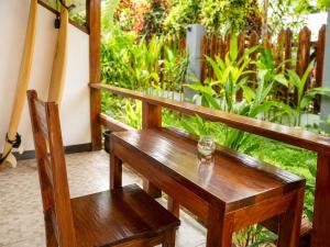 a wooden bench sitting on top of a porch at Pascoe's Units Siargao- Suites in General Luna