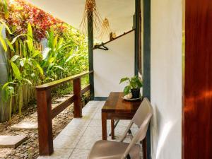 a balcony with a wooden table and a chair at Pascoe's Units Siargao- Suites in General Luna +1 photo