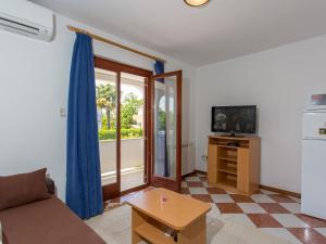 a living room with a couch and a television at Apartments AVA in Poreč