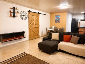 a living room with a couch and a fireplace at L'Eden du Piton des Roches in La Plaine des Palmistes