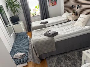 a bedroom with two beds with towels on them at Morfslottet in Gothenburg