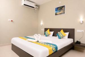 a bedroom with a large bed with towels on it at Vilasa Prime Hotel in Guwahati