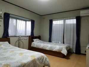 a bedroom with two beds and a window at Bibi Vacation Rental Only 2 groups per day Vacation STAY 1284 in Sakai +12 photos