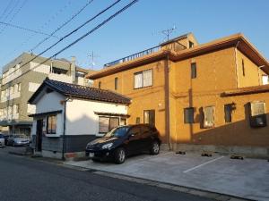 a car parked in a parking lot next to a building at Bibi Vacation Rental Only 2 groups per day Vacation STAY 1284 in Sakai