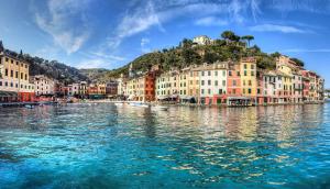 a large body of water with buildings on a hill at Royal Suite in Genoa