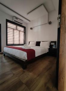 a bedroom with a large bed with a red blanket at Forest edge Villa - 3 bedrooms in Ambalavayal +16 photos
