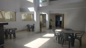 a dining room with tables and chairs in a building at Lagoa Flats in Lagoa Santa +7 photos
