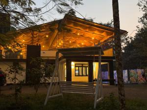 a small house with a porch in front of it at Forest edge Villa - 3 bedrooms in Ambalavayal