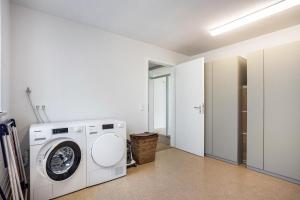 a laundry room with a washing machine in it at Blaues Haus in Buchloe