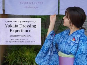 a woman standing in front of a sign at LAZULI Hiroshima Hotel and Lounge in Hiroshima