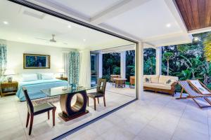 a living room with a bed and a glass table at Alaya Verde Bed & Breakfast in Ringtail Creek