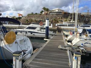 a group of boats docked at a dock at Puerto Calero Boat in Puerto Calero