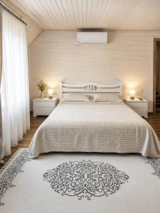 a bedroom with a large bed with two night stands at Вілла Смерекова хата in Kelechin